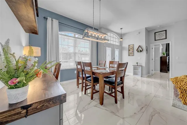 a kitchen with stainless steel appliances granite countertop a stove top oven a sink dishwasher and white cabinets with wooden floor