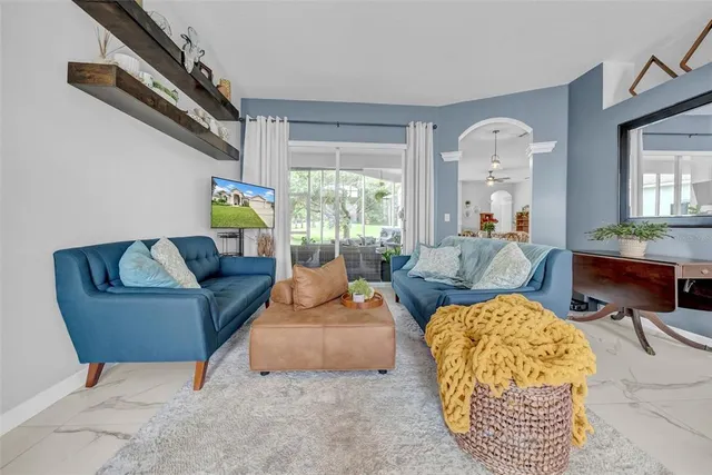 a kitchen with stainless steel appliances granite countertop a stove top oven a sink dishwasher and a refrigerator with white cabinets