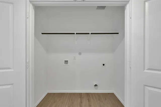 a view of walk in closet with empty racks