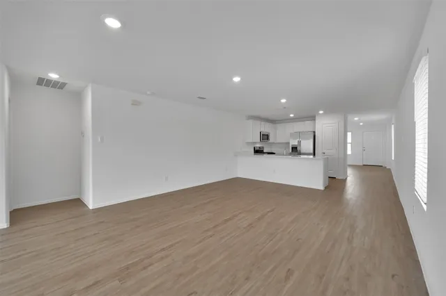 a view of a kitchen with a sink and wooden floor