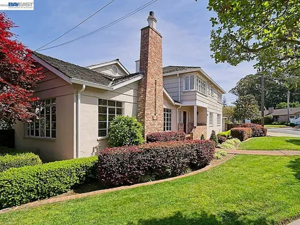a front view of a house with garden