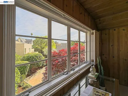 a front view of a house with a yard and potted plants