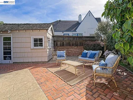 a front view of a house with a yard and an trees
