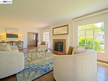a living room with fireplace furniture and a wooden floor