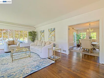 a view of a dining room with furniture window and wooden floor