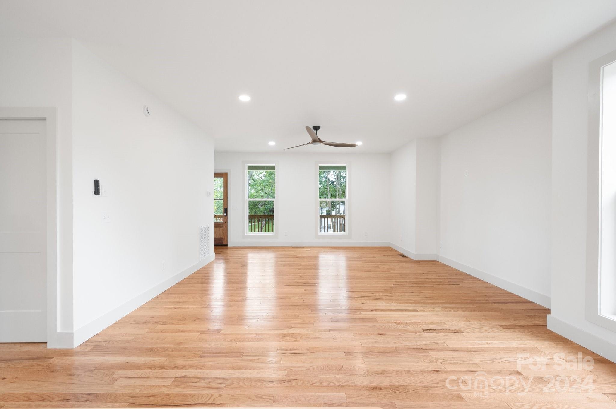 30 Spaulding Road Candler, NC 28715 - Photo 11 of 44 a view of an empty room with wooden floor and windows