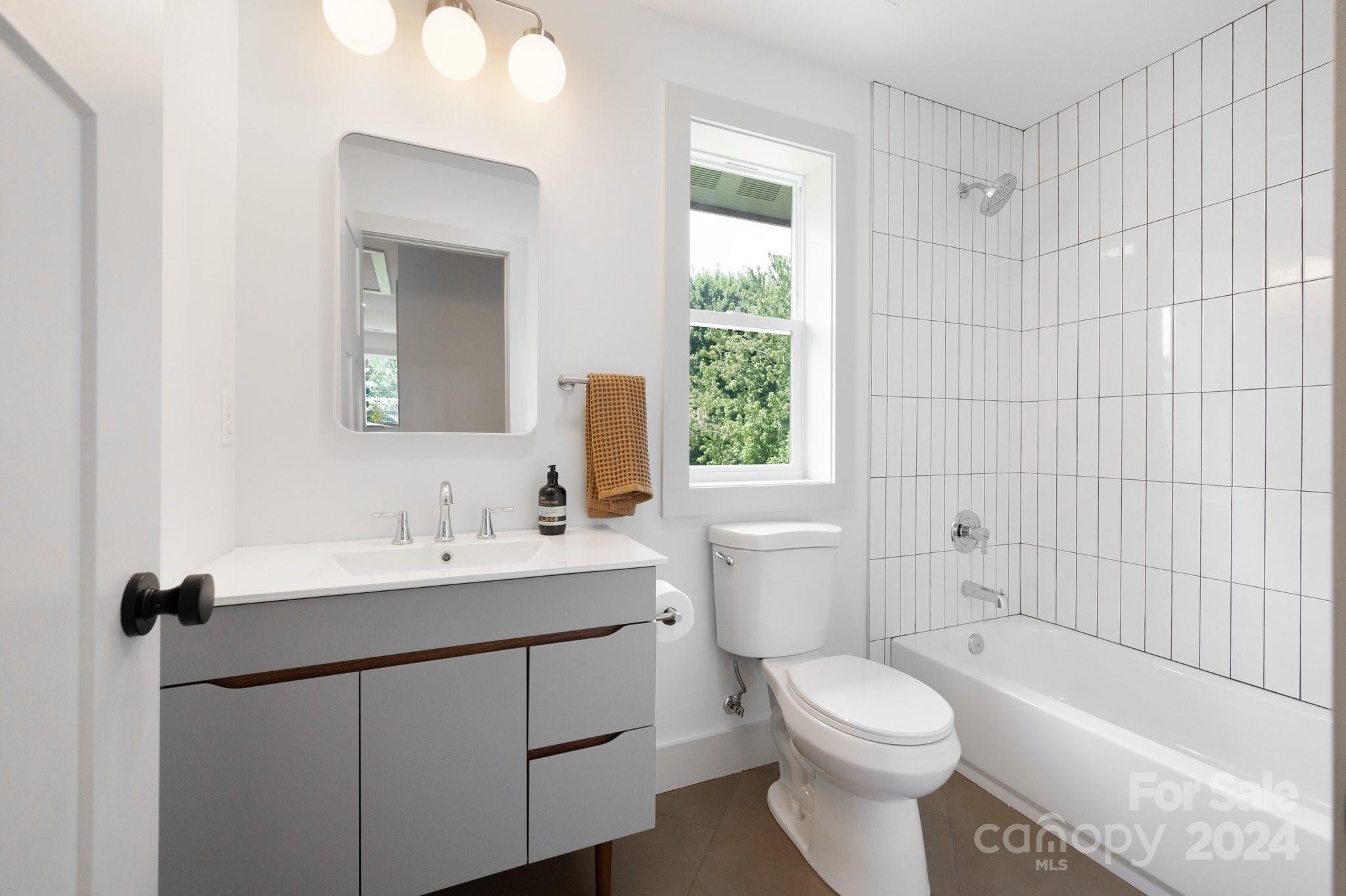 30 Spaulding Road Candler, NC 28715 - Photo 27 of 44 a bathroom with a sink toilet vanity and bathtub