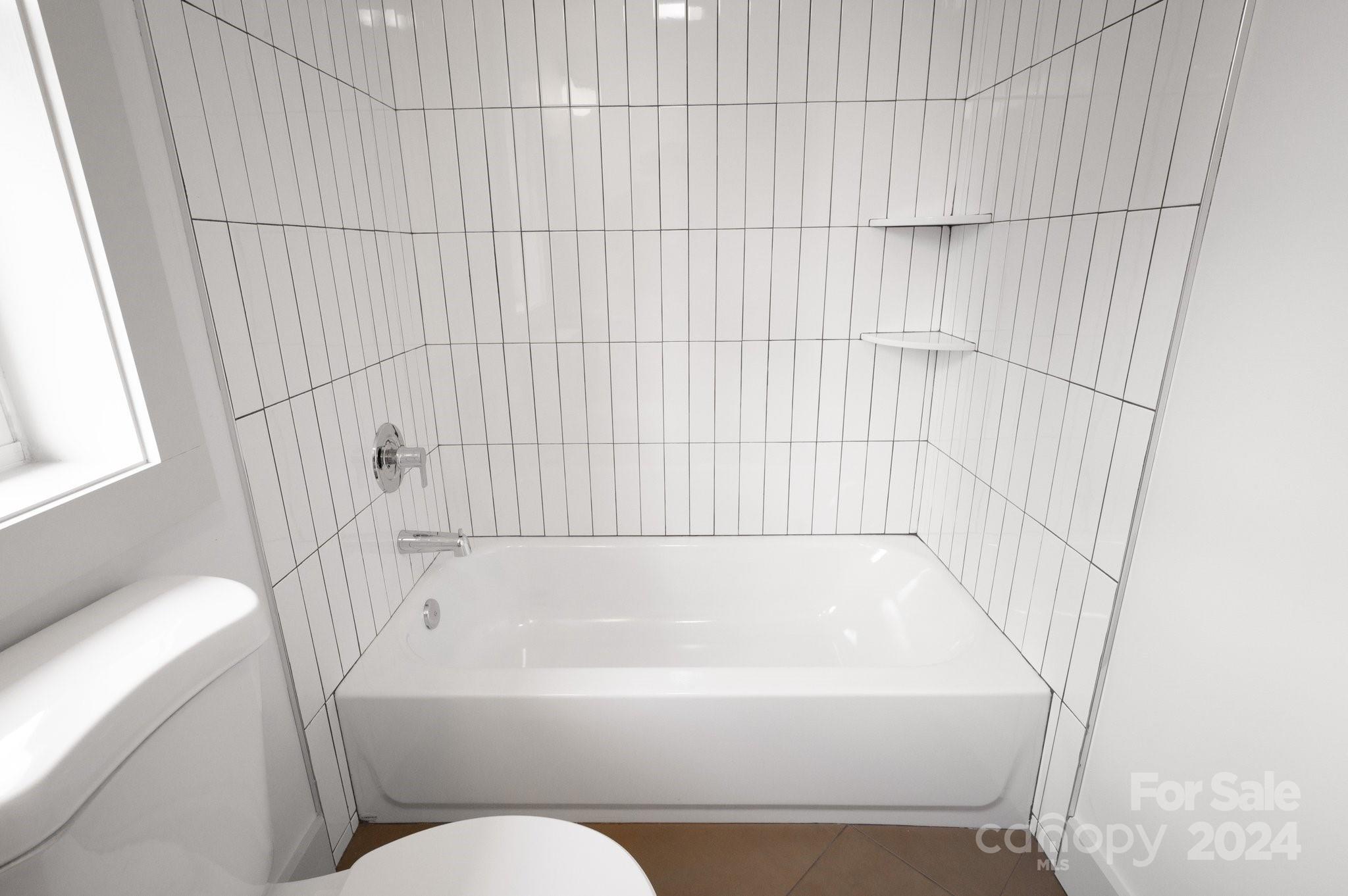 30 Spaulding Road Candler, NC 28715 - Photo 28 of 44 a bathroom with a bathtub and shower