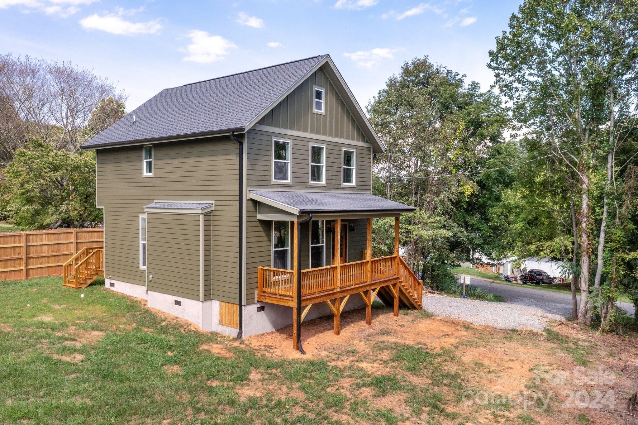 30 Spaulding Road Candler, NC 28715 - Photo 42 of 44 a front view of a house with a yard and a fence