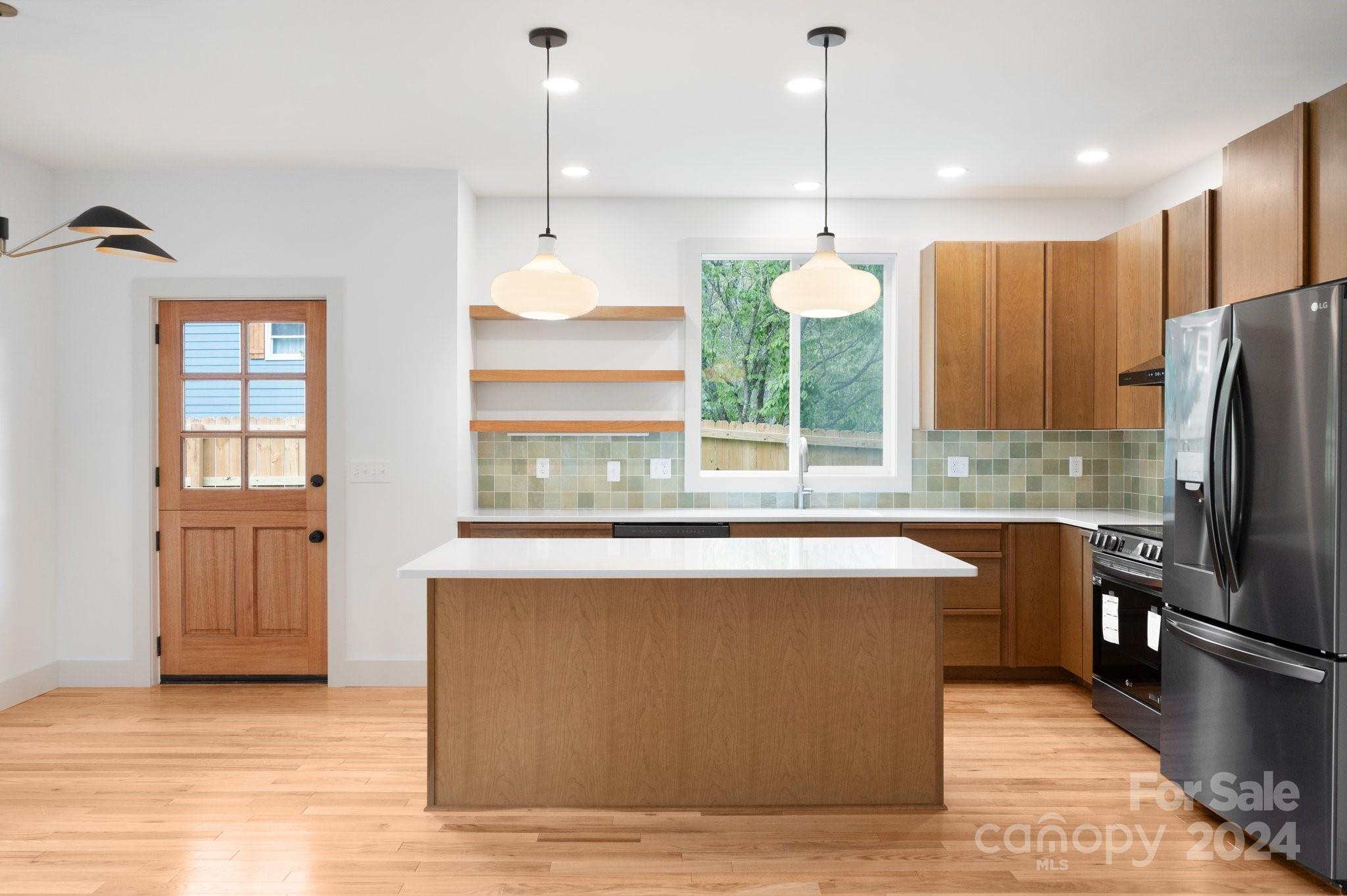 30 Spaulding Road Candler, NC 28715 - Photo 5 of 44 a kitchen with kitchen island a counter top space appliances and a window