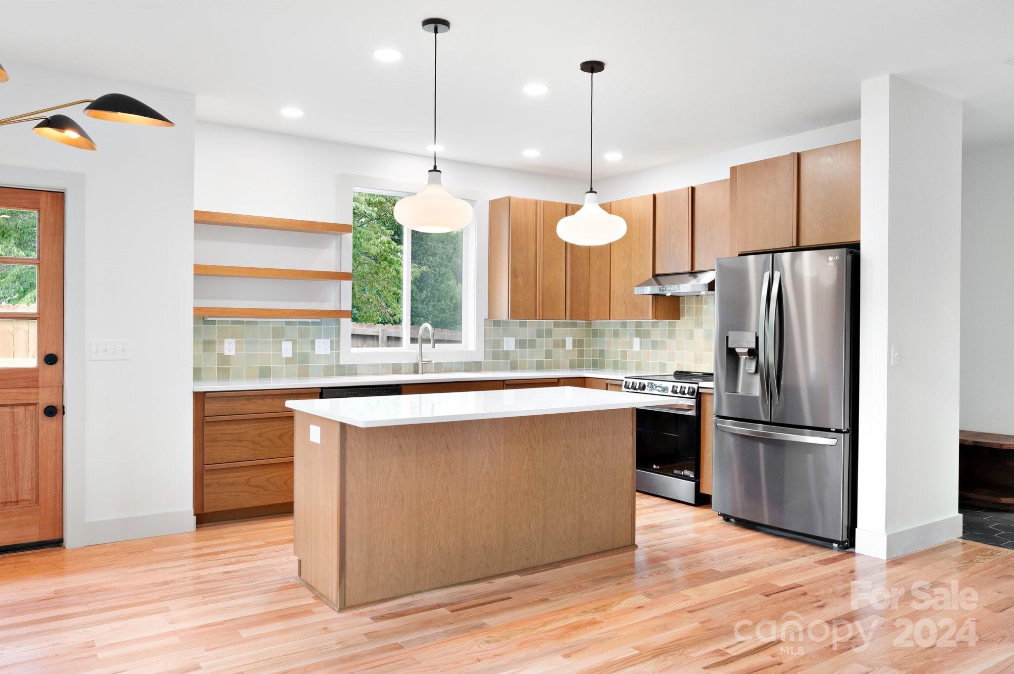30 Spaulding Road Candler, NC 28715 - Photo 6 of 44 a kitchen with stainless steel appliances granite countertop a refrigerator a sink and a stove