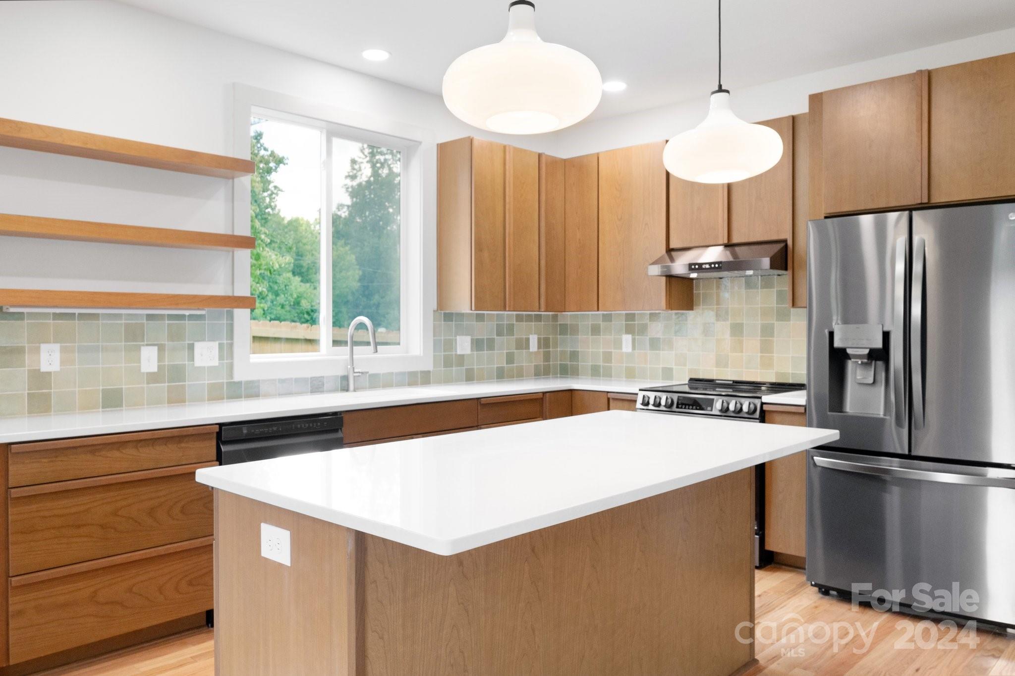 30 Spaulding Road Candler, NC 28715 - Photo 7 of 44 a kitchen that has a sink a counter top stainless steel appliances and cabinets