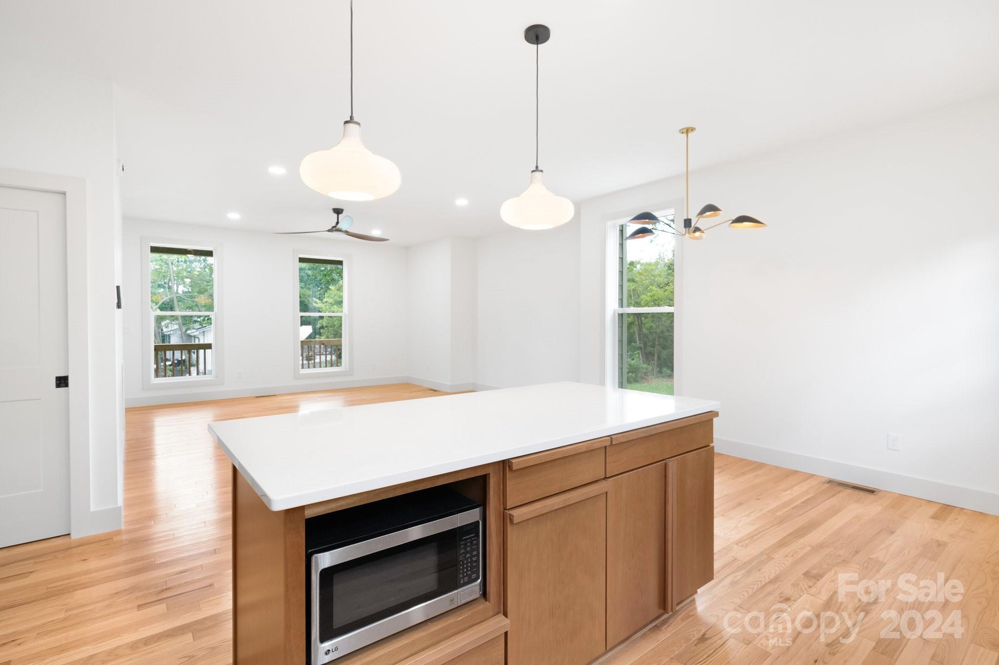 30 Spaulding Road Candler, NC 28715 - Photo 9 of 44 a kitchen with a stove and a wooden floor