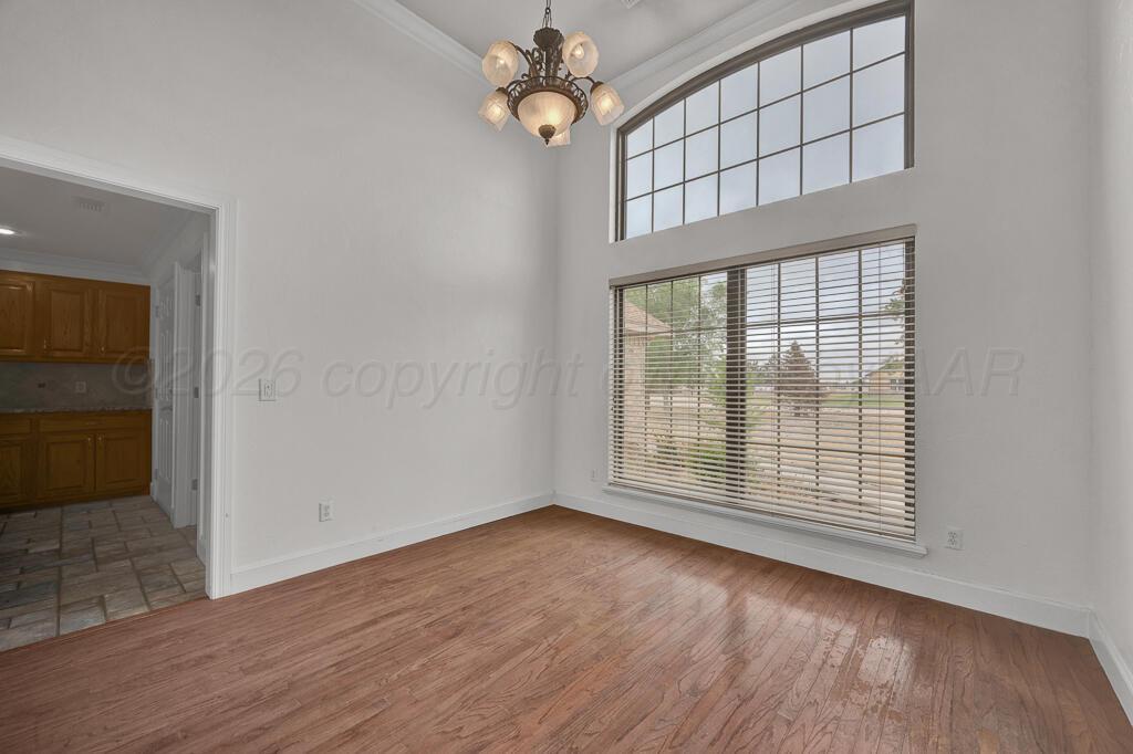 19933 Indian Spring Trail Bushland, TX 79124 - Photo 7 of 32 wooden floor in an empty room with a window