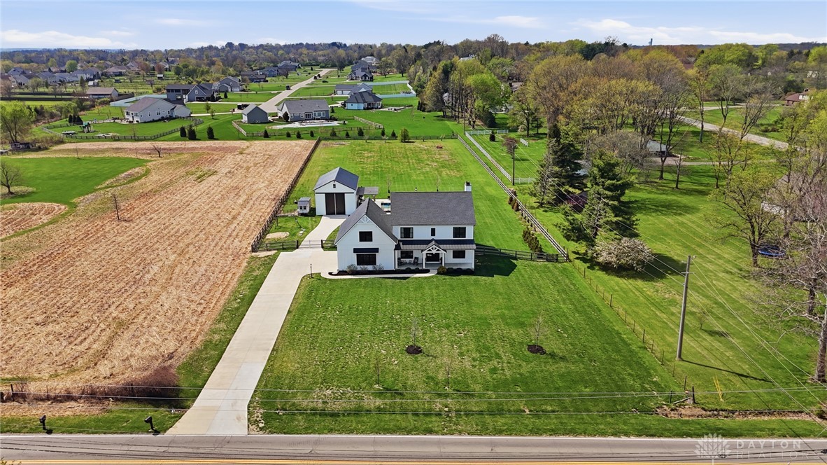 This charming residence offers expansive green spaces and a private driveway.