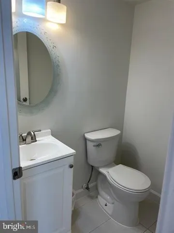 a white toilet sitting next to a bathroom sink