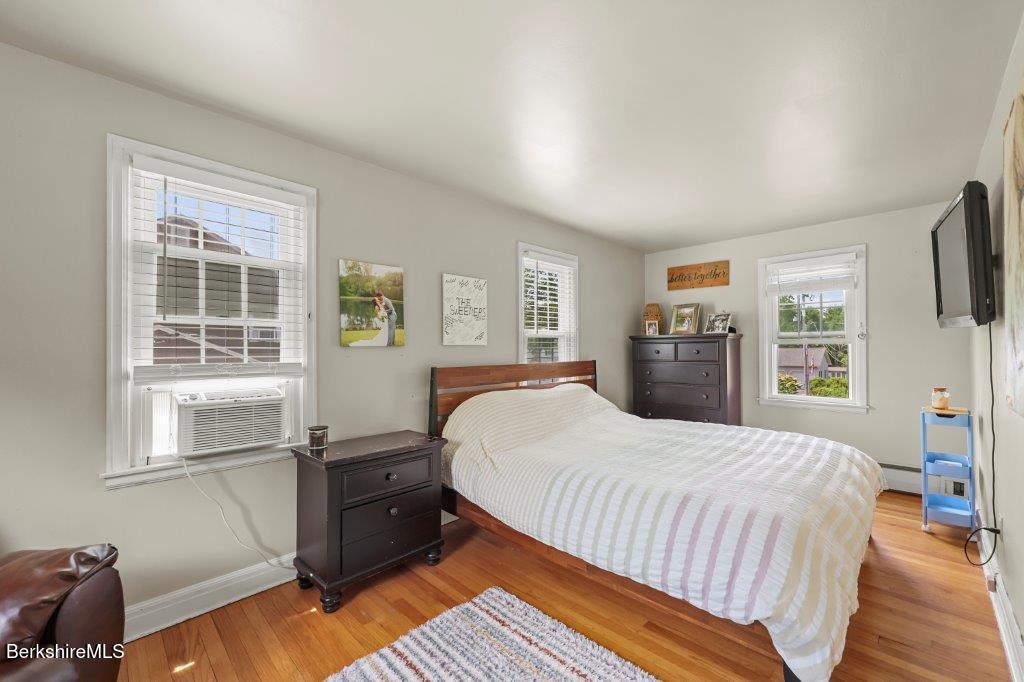 33 Eleanor Road Pittsfield, MA 01201 - Photo 28 of 45 a bedroom with a bed and wooden floor