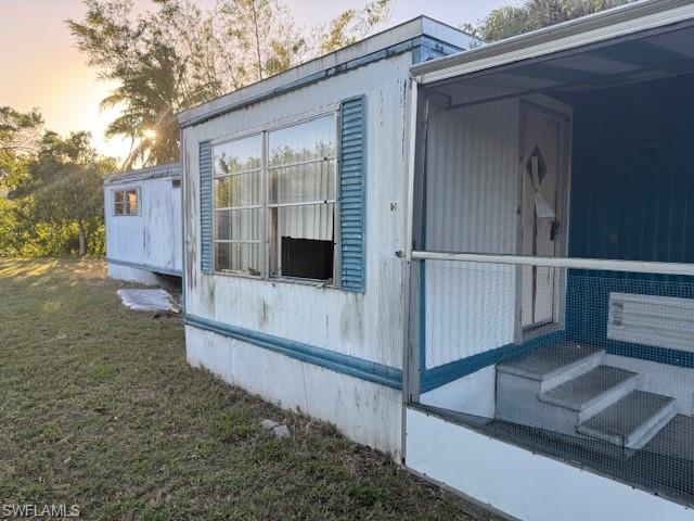 Property exterior at dusk with a lawn