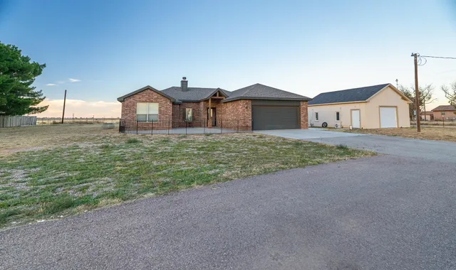 a living room with furniture wooden floor and a large window