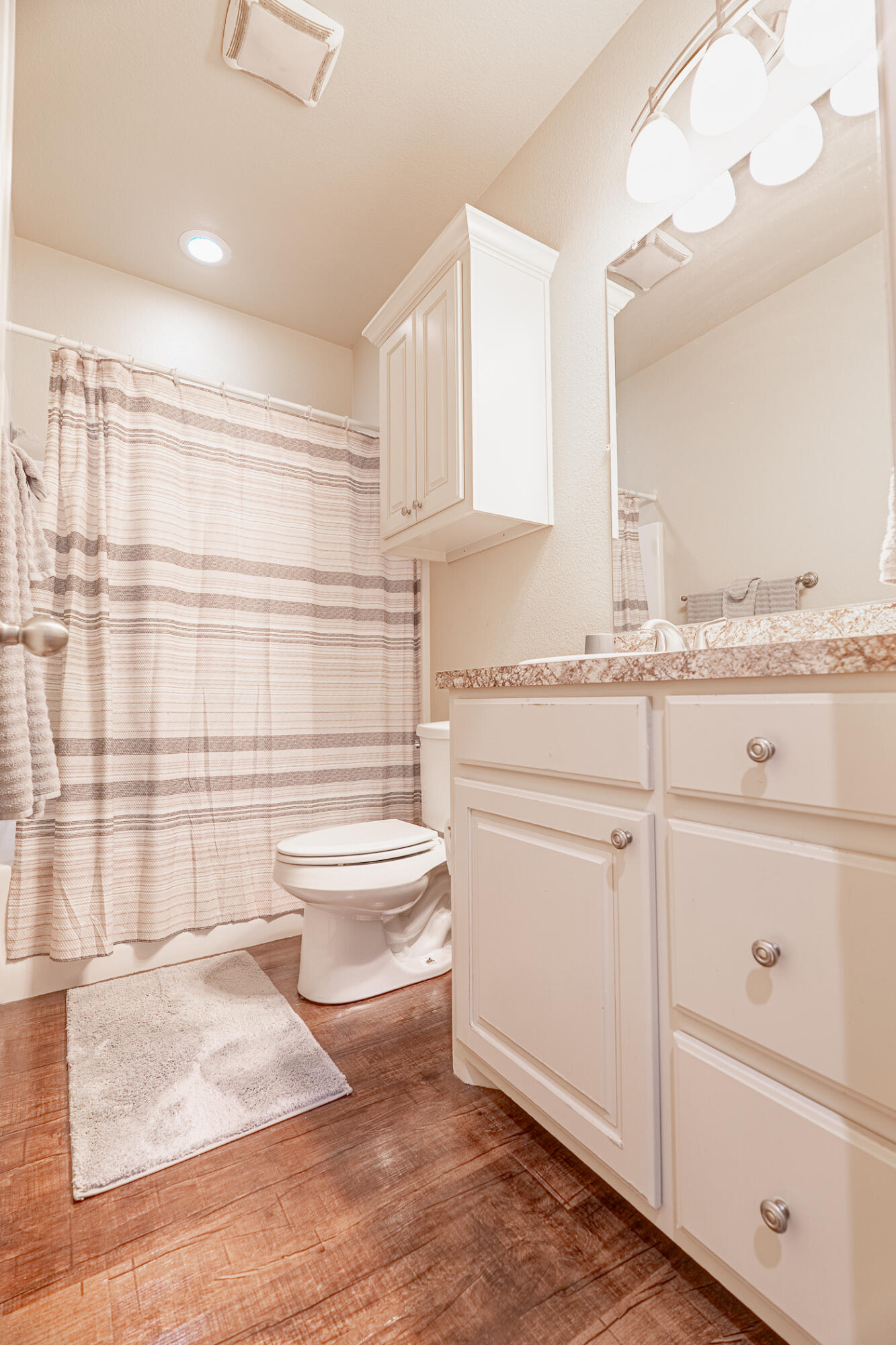 1620 Farm To Market 41 Lubbock, TX 79423 - Photo 24 of 37 a bathroom with a granite countertop sink mirror vanity and toilet