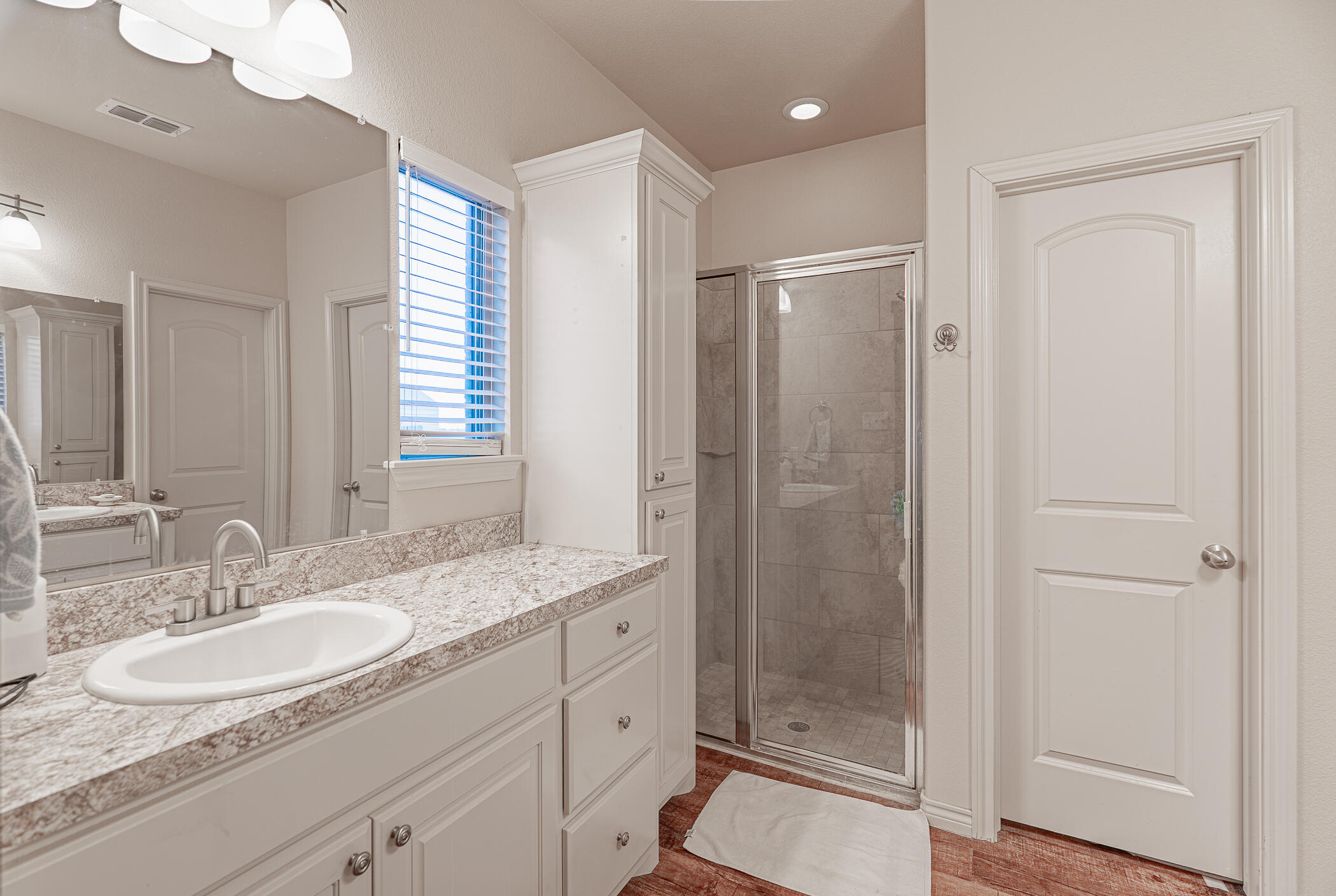 1620 Farm To Market 41 Lubbock, TX 79423 - Photo 31 of 37 a bathroom with a granite countertop sink a mirror a vanity and a shower