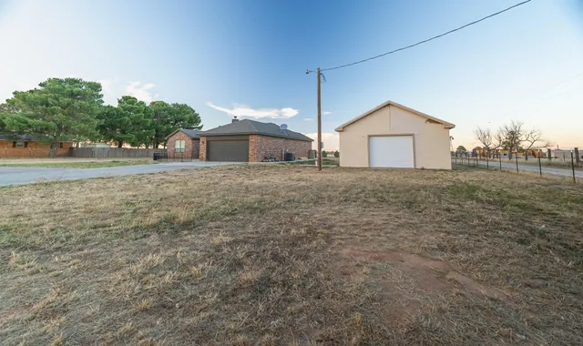 a kitchen with stainless steel appliances kitchen island granite countertop a stove a refrigerator and a dining table