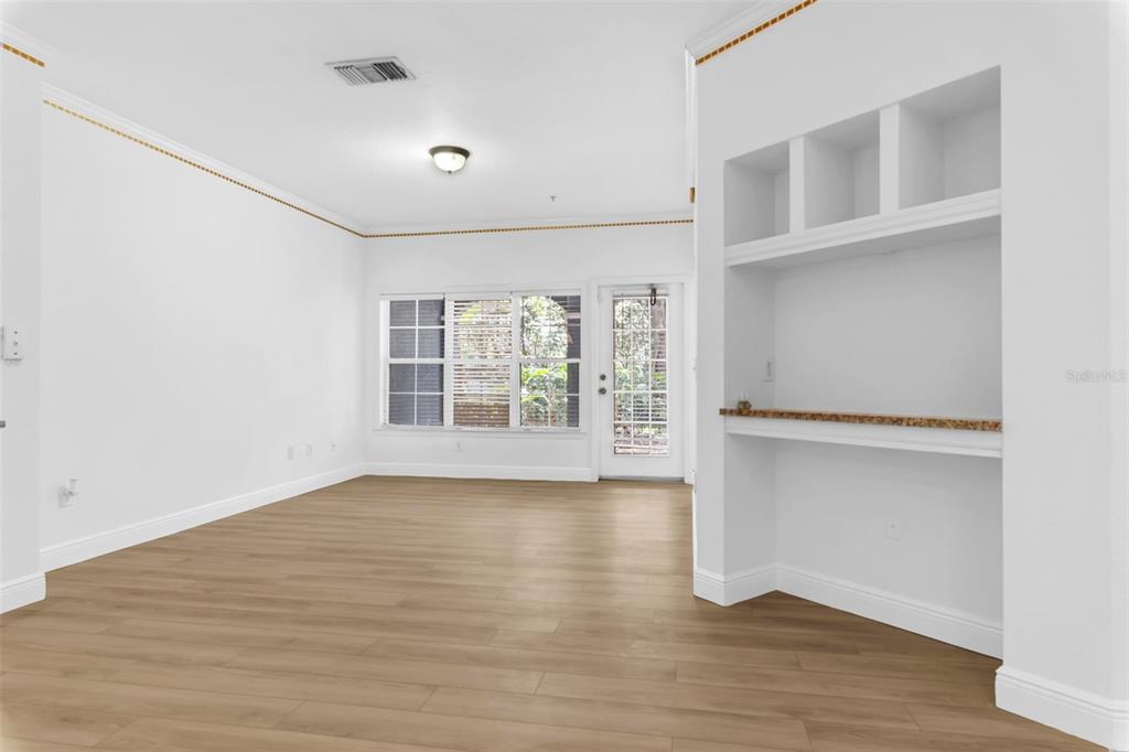 3561 Conroy Road, Unit 216 Orlando, FL 32839 - Photo 11 of 32 a view of an empty room with a window and wooden floor