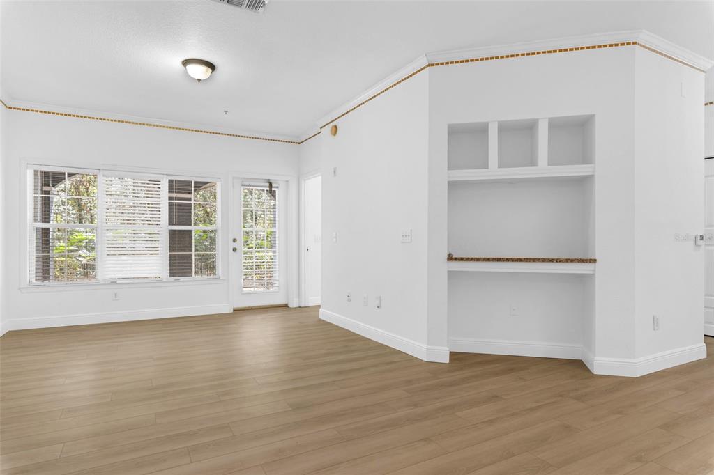 3561 Conroy Road, Unit 216 Orlando, FL 32839 - Photo 12 of 32 a view of an empty room with a window and wooden floor