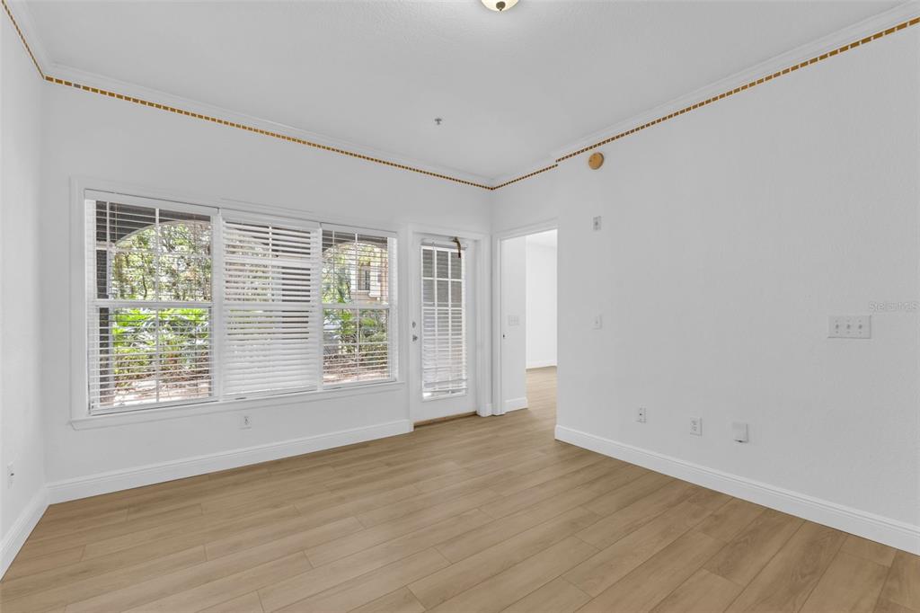 3561 Conroy Road, Unit 216 Orlando, FL 32839 - Photo 13 of 32 a view of an empty room with wooden floor and a window