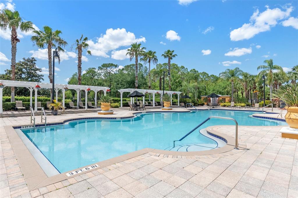 3561 Conroy Road, Unit 216 Orlando, FL 32839 - Photo 27 of 32 a view of a swimming pool with a table and chairs
