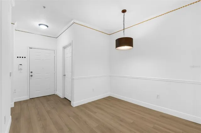 a view of a room with wooden floor and a window