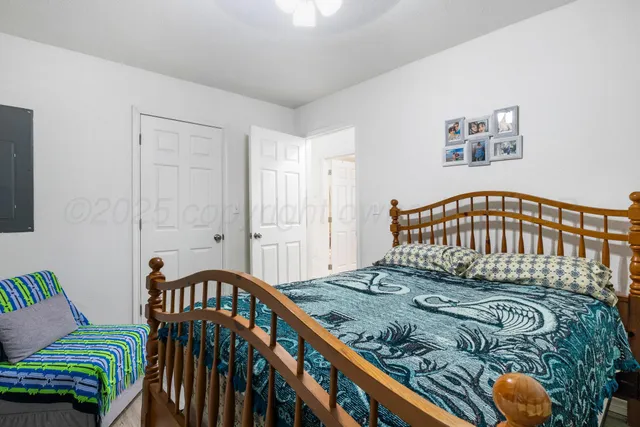 a bedroom with a bed and a book shelf