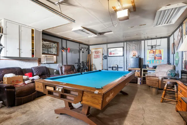 a room with furniture and pool table