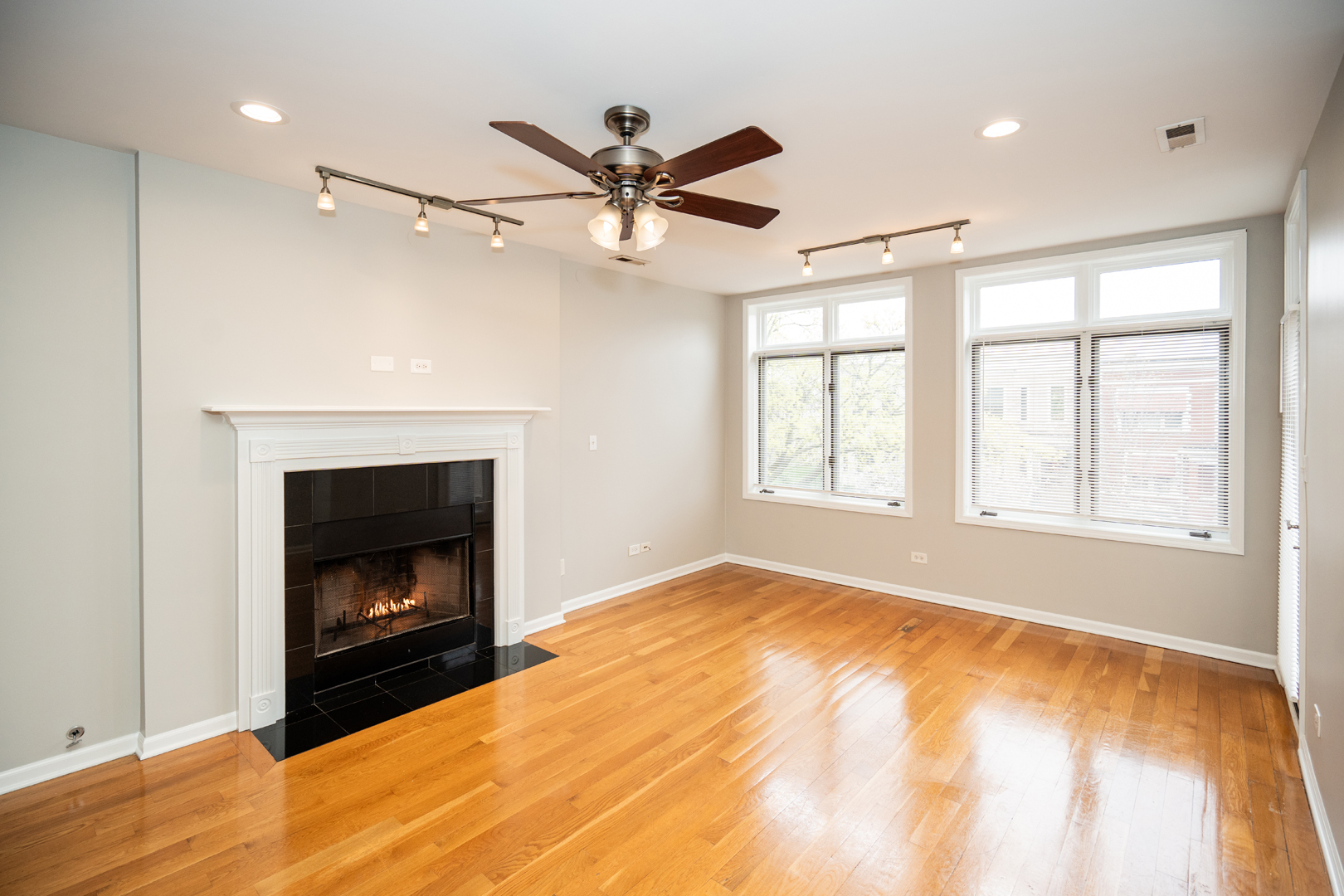 6543 South Ingleside Avenue, Unit 2 Chicago, IL 60637 - Photo 4 of 15 a view of empty room with a fireplace and fan