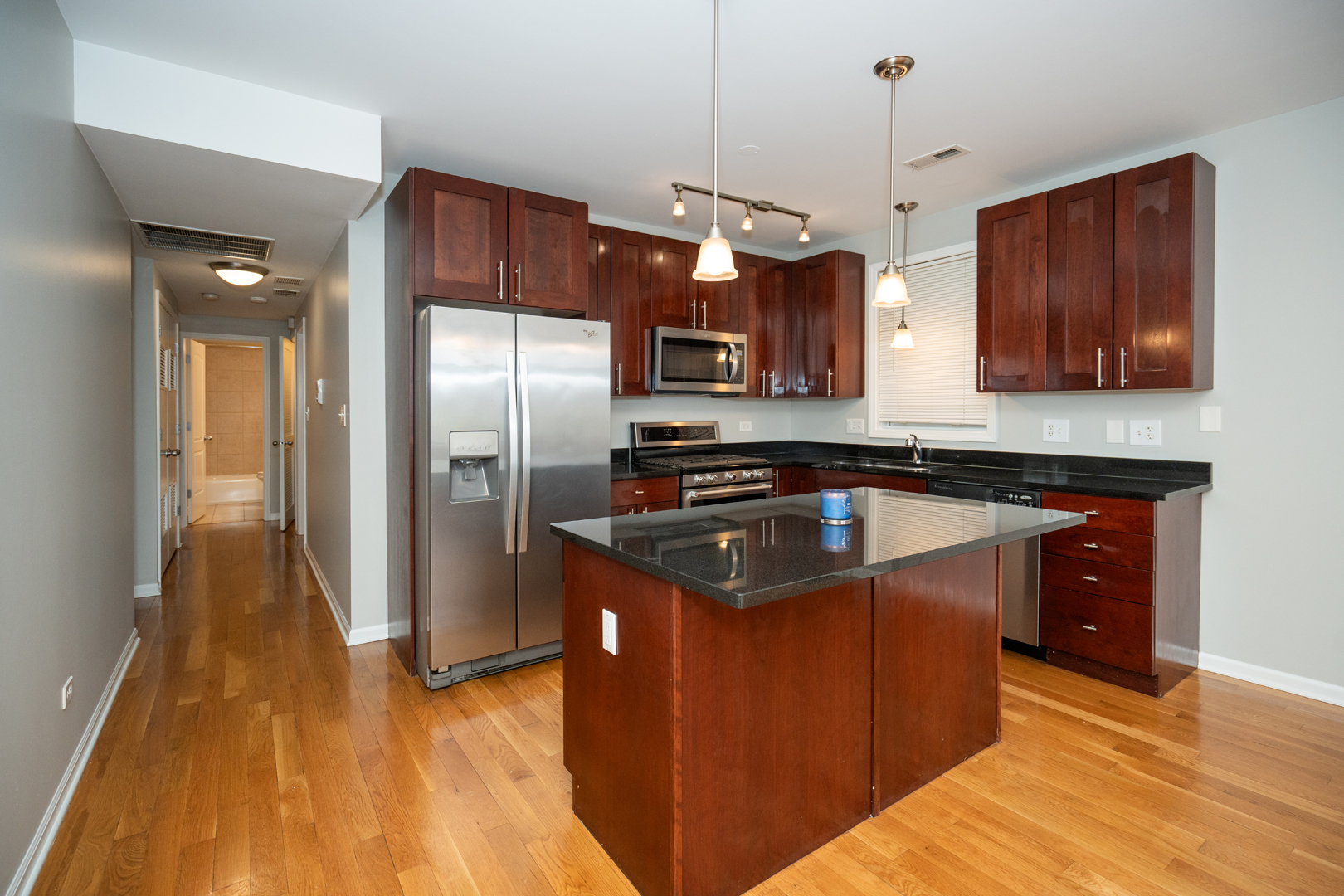 6543 South Ingleside Avenue, Unit 2 Chicago, IL 60637 - Photo 5 of 15 a kitchen with stainless steel appliances granite countertop a sink a stove and a refrigerator