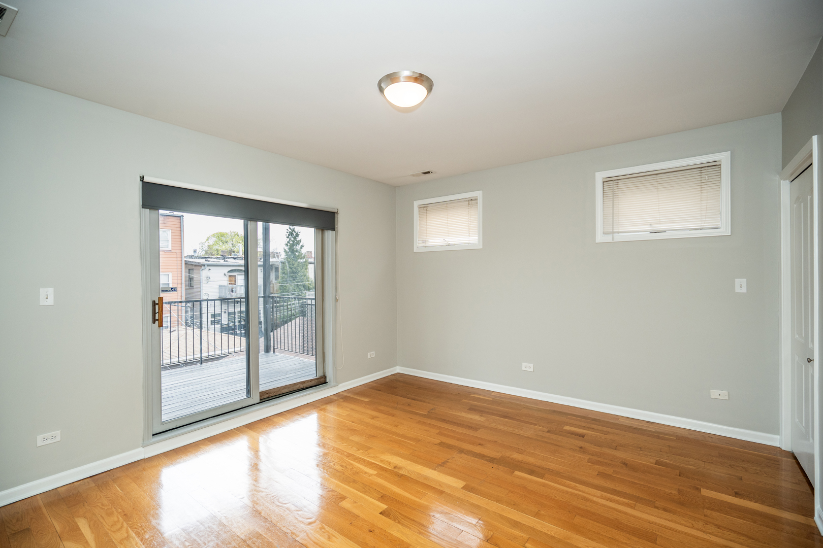 6543 South Ingleside Avenue, Unit 2 Chicago, IL 60637 - Photo 9 of 15 a view of an empty room with wooden floor and a window