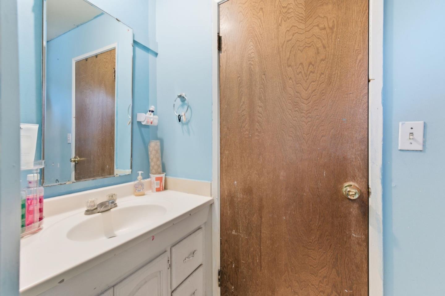 361 North 10th Street San Jose, CA 95112 - Photo 11 of 14 a bathroom with a sink and a mirror