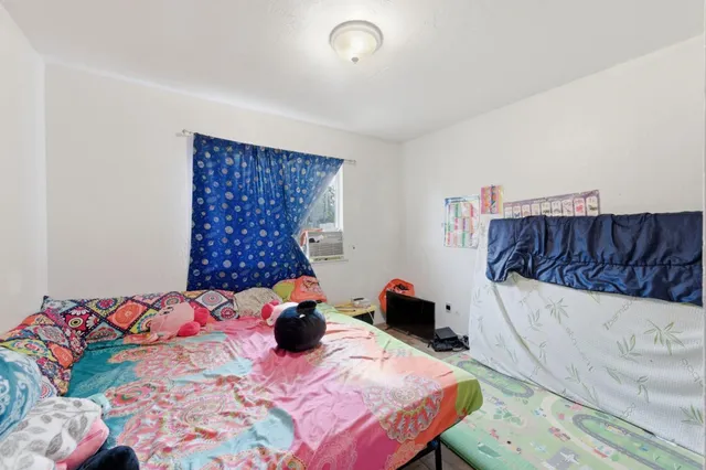 a bedroom with a bed and a couch