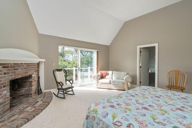 73 Barley Neck Road Orleans, MA 02653 - Photo 18 of 35 a bedroom with a bed and a fireplace