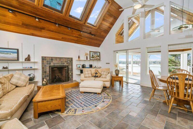 73 Barley Neck Road Orleans, MA 02653 - Photo 8 of 35 a living room with furniture a fireplace and a table