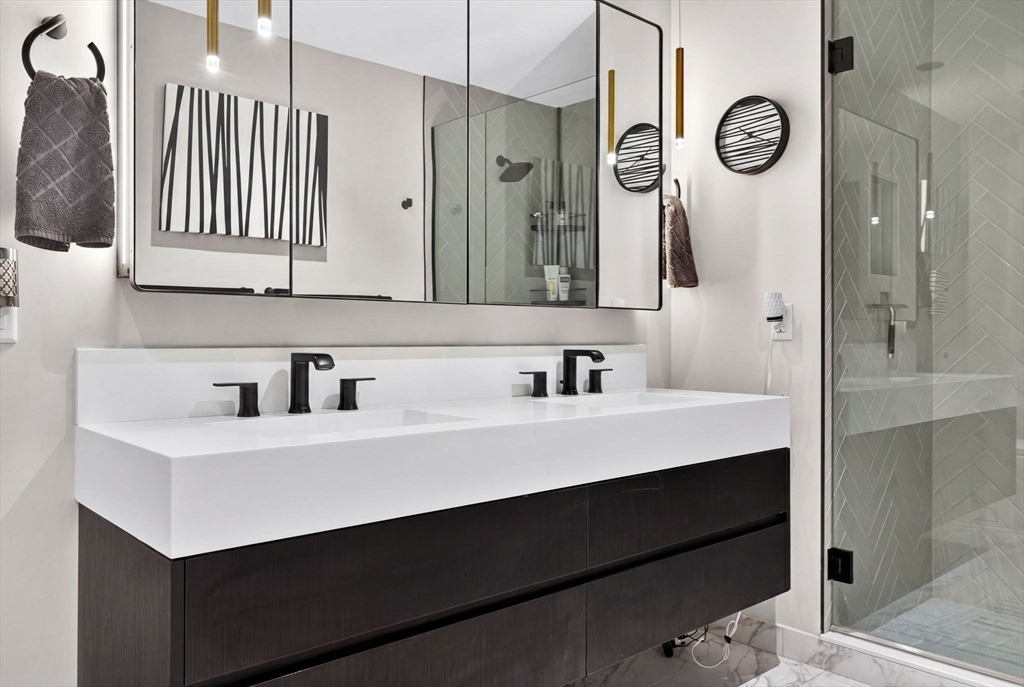 55 Lagrange Street, Unit 409 Boston, MA 02111 - Photo 16 of 29 a bathroom with a sink vanity and a mirror