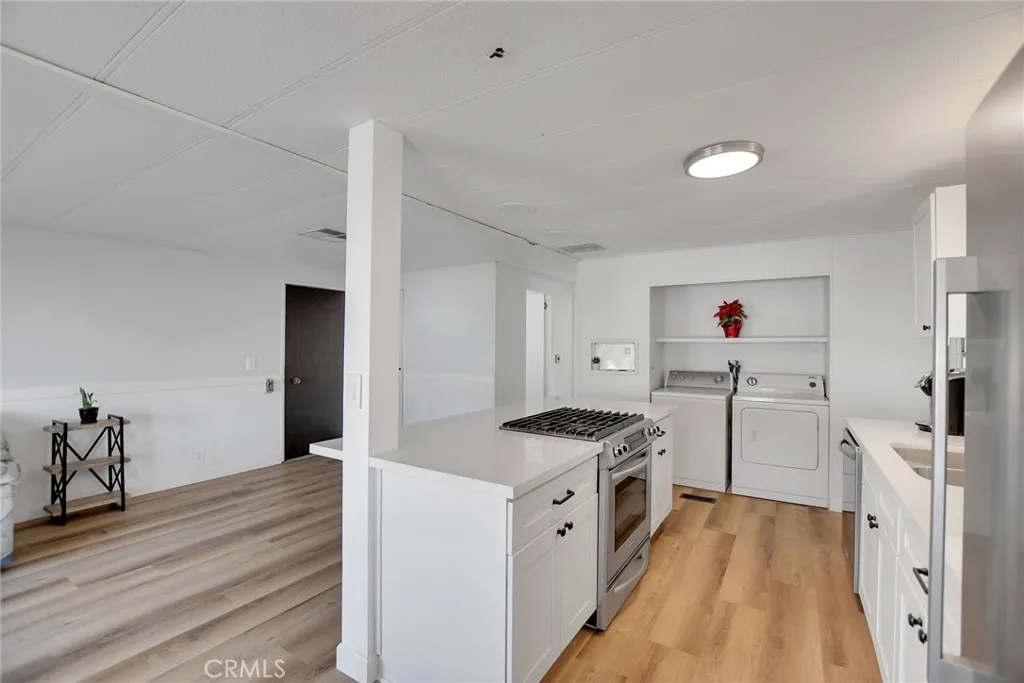 840 Foothill, Unit 27 Azusa, CA 91702 - Photo 16 of 30 a kitchen with cabinets and wooden floor