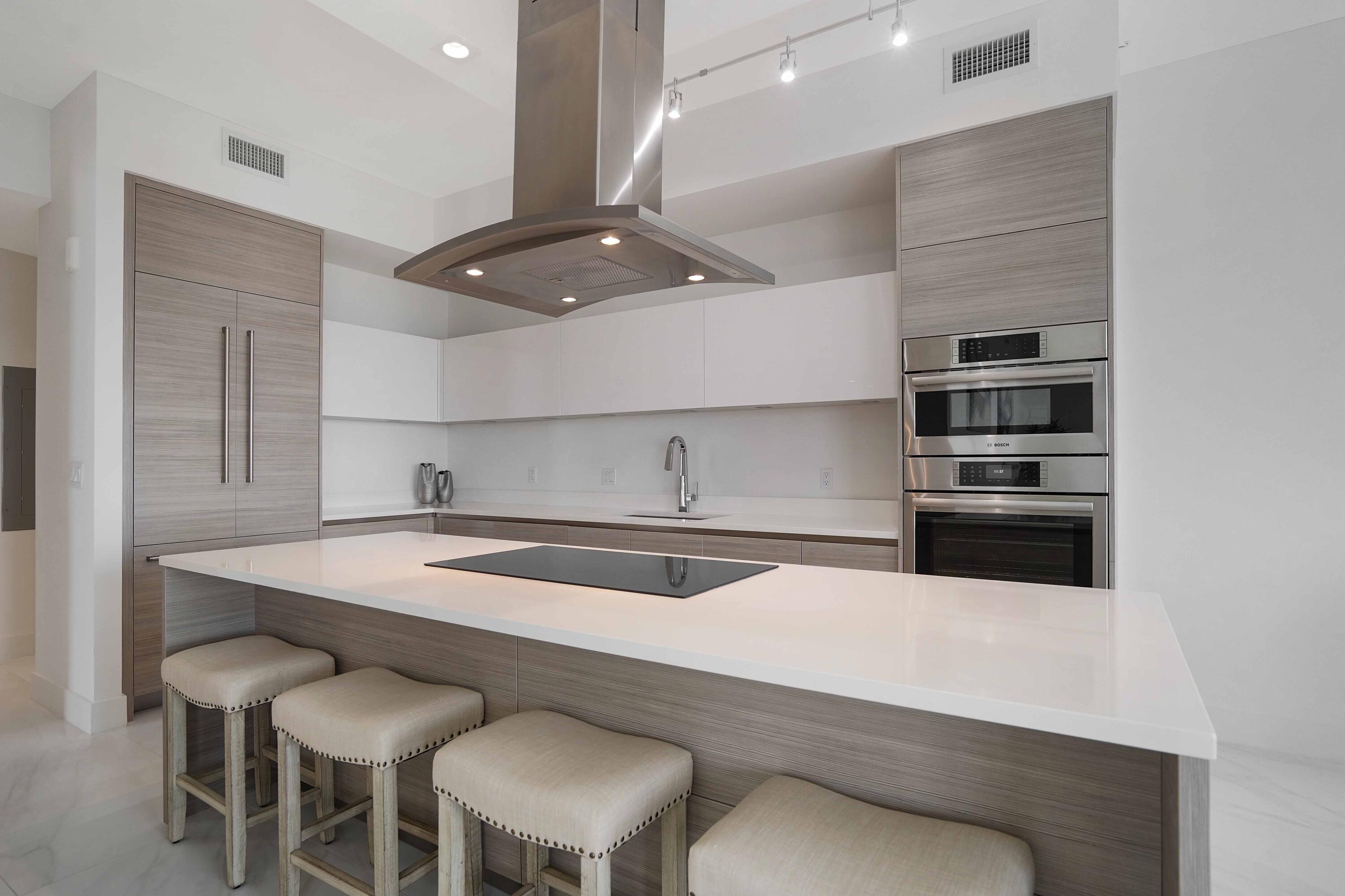 155 East Boca Raton Road, Unit 1116 Boca Raton, FL 33432 - Photo 32 of 80 a kitchen with stainless steel appliances a sink and a refrigerator