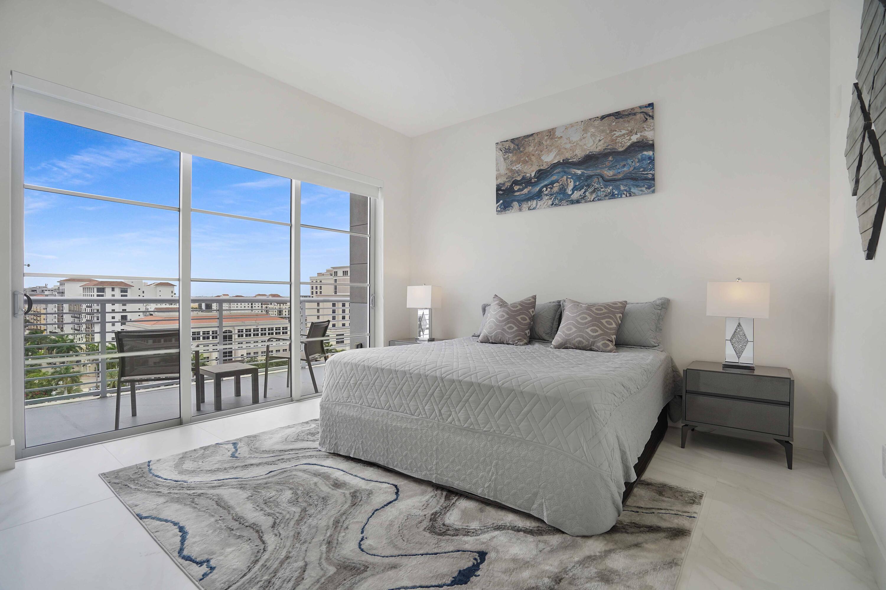 155 East Boca Raton Road, Unit 1116 Boca Raton, FL 33432 - Photo 39 of 80 a spacious bedroom with a bed a table and balcony