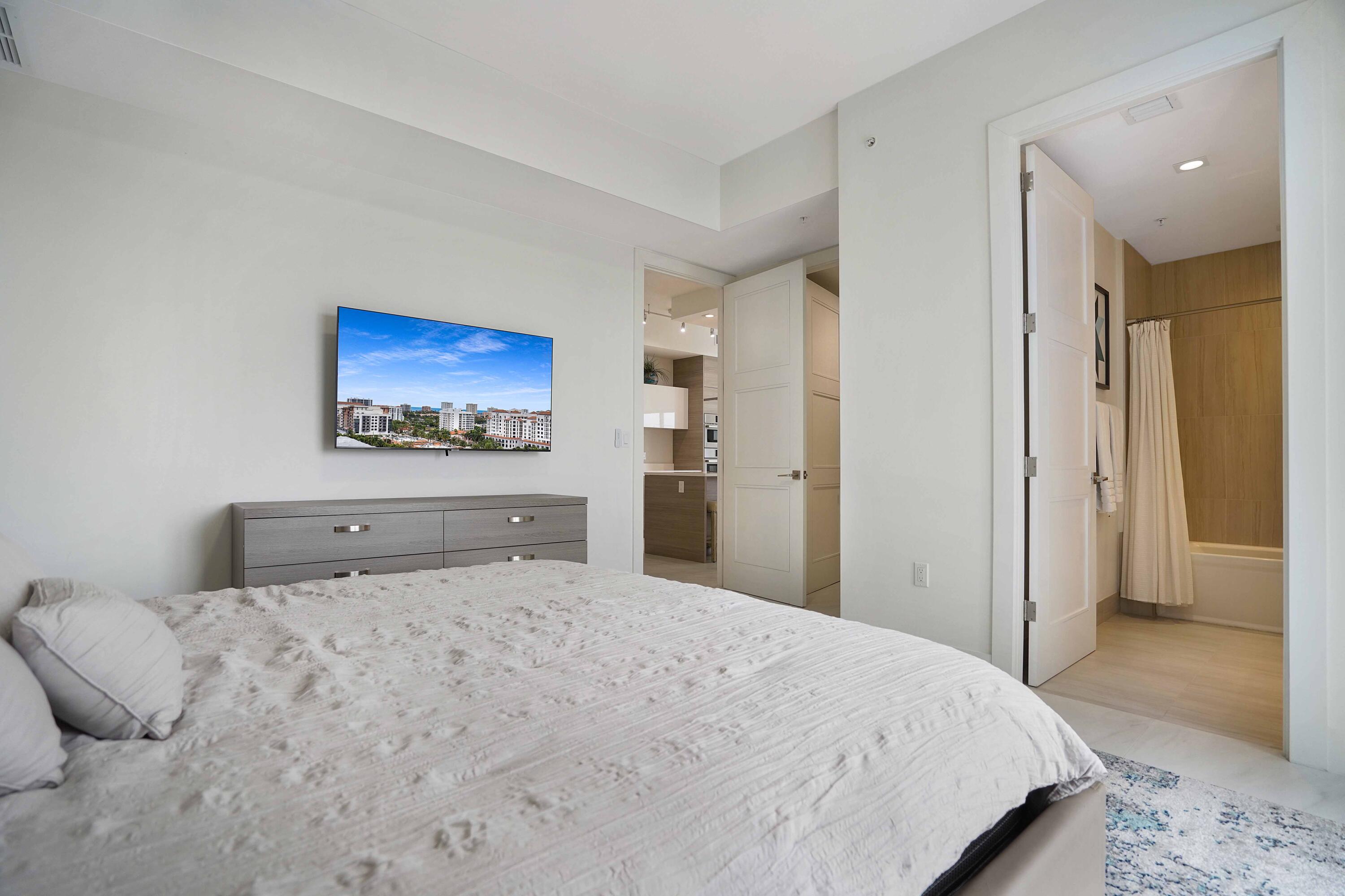 155 East Boca Raton Road, Unit 1116 Boca Raton, FL 33432 - Photo 45 of 80 a bedroom with a bed and a painting on the wall