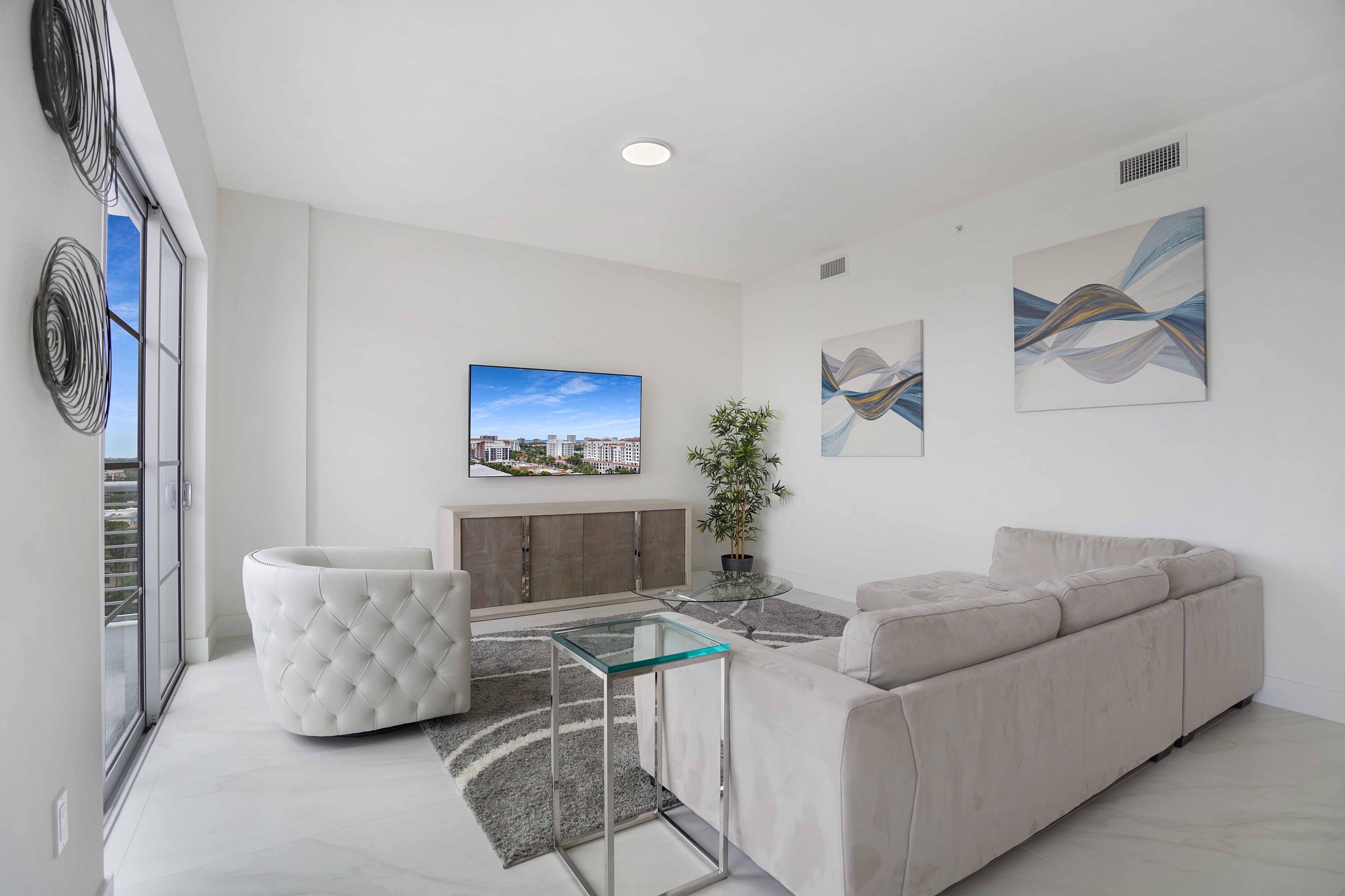 155 East Boca Raton Road, Unit 1116 Boca Raton, FL 33432 - Photo 51 of 80 a living room with furniture and a flat screen tv