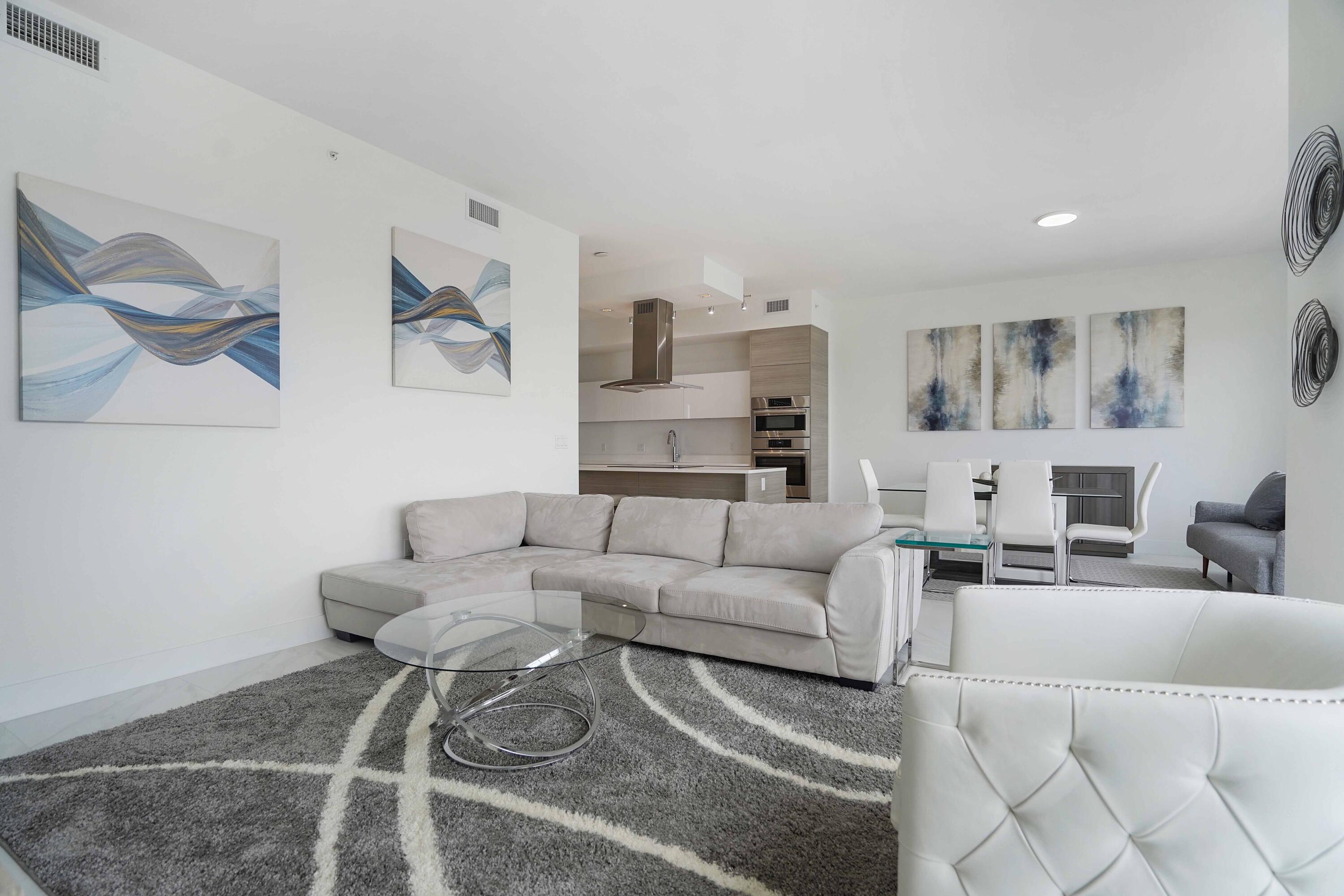 155 East Boca Raton Road, Unit 1116 Boca Raton, FL 33432 - Photo 53 of 80 a living room with furniture and a couch