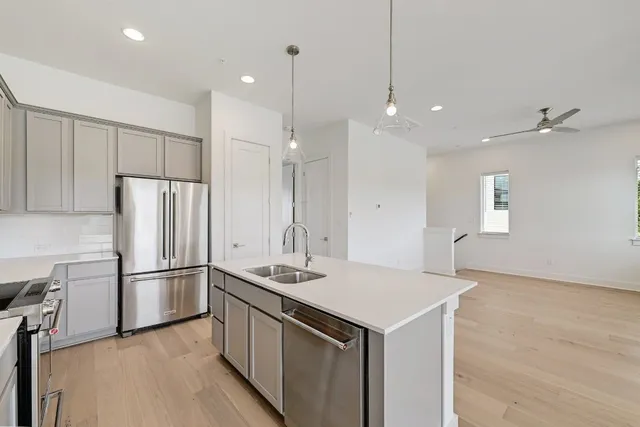 an empty room with windows and ceiling fan