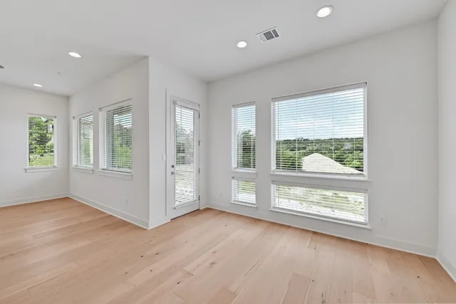 an empty room with windows and closet