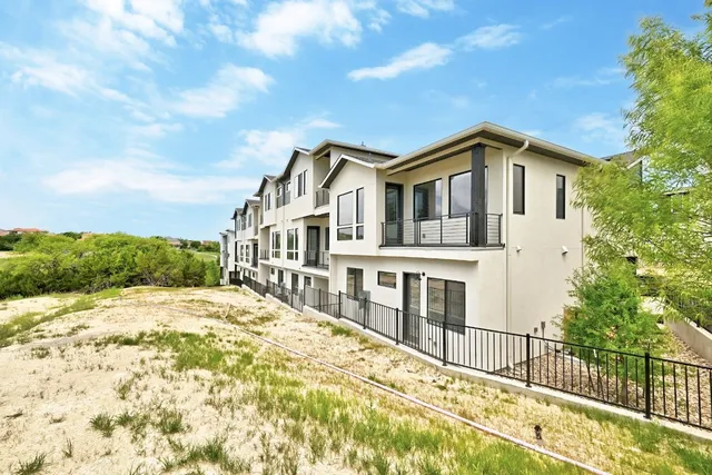a view of a house with swimming pool and sitting area